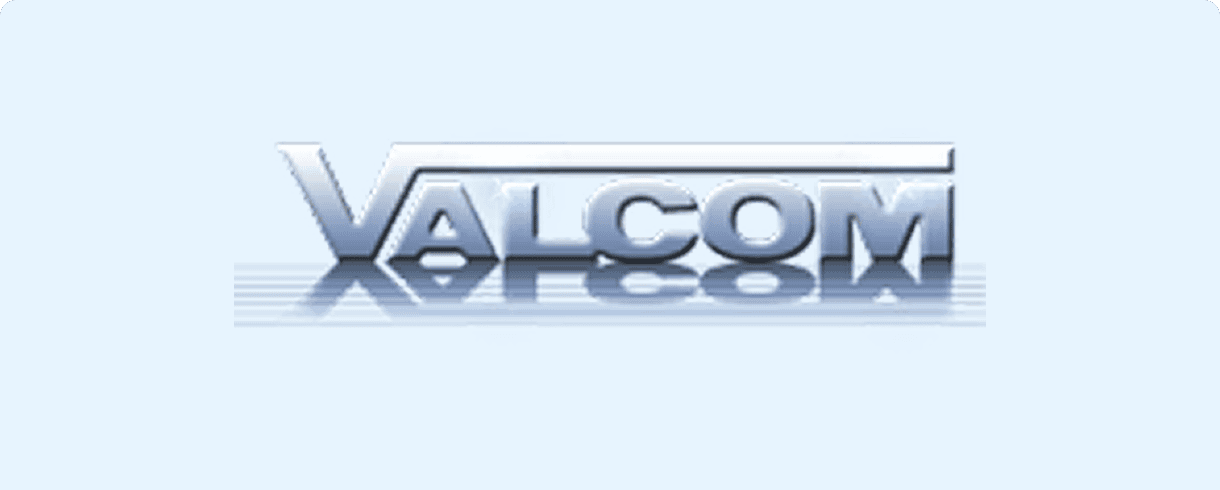 Silver VALCOM text on light blue background